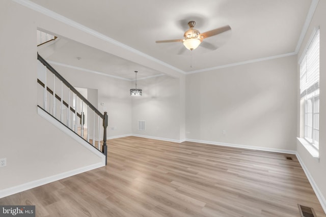 20524 Blue Heron Ter, Sterling, VA 20165 - unfurnished living room featuring healthy amount of natural light, stairway, wood finished floors, ceiling fan, and ornamental molding