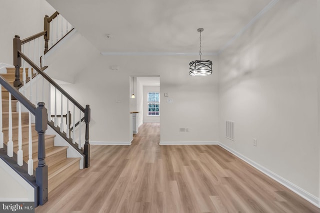 20524 Blue Heron Ter, Sterling, VA 20165 - unfurnished dining area featuring light wood finished floors, stairs, and crown molding