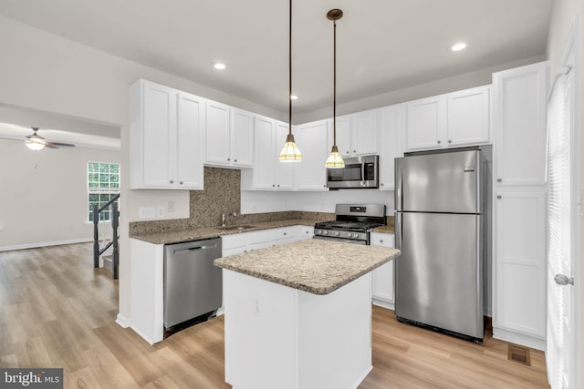 20524 Blue Heron Ter, Sterling, VA 20165 - kitchen with stainless steel appliances, white cabinetry, a ceiling fan, light wood finished floors, and recessed lighting