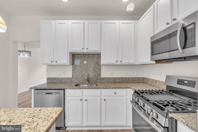 20524 Blue Heron Ter, Sterling, VA 20165 - kitchen featuring stainless steel appliances, white cabinetry, light stone countertops, recessed lighting, and light wood-style flooring