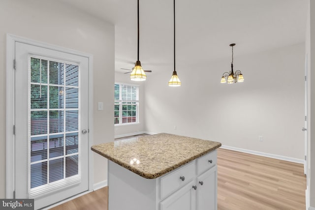 20524 Blue Heron Ter, Sterling, VA 20165 - kitchen with light wood finished floors, white cabinets, a chandelier, a center island, and decorative light fixtures