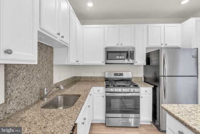 20524 Blue Heron Ter, Sterling, VA 20165 - kitchen featuring stainless steel appliances, white cabinets, recessed lighting, light stone counters, and backsplash