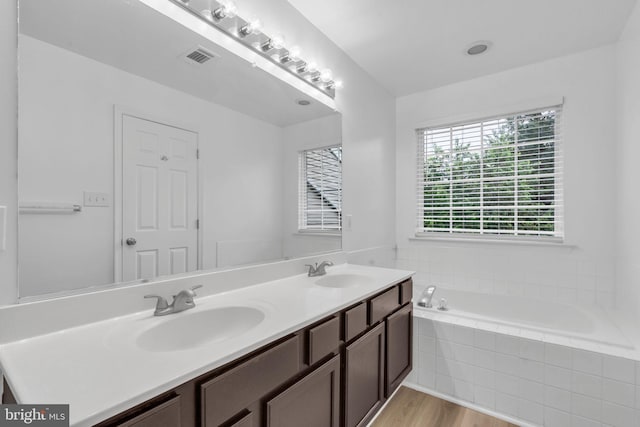 20524 Blue Heron Ter, Sterling, VA 20165 - bathroom with double vanity, a bath, and wood finished floors
