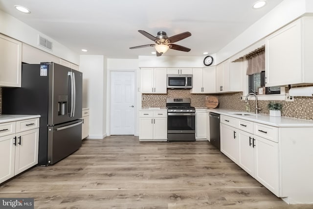 26 Hillcroft Rd, Berlin, NJ 08009 - kitchen featuring appliances with stainless steel finishes, a sink, ceiling fan, decorative backsplash, and recessed lighting