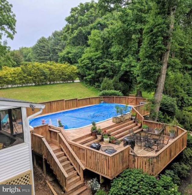 601 Cockeys Mill Rd, Reisterstown, MD 21136 - view of pool featuring a deck, stairs, and a wooded view