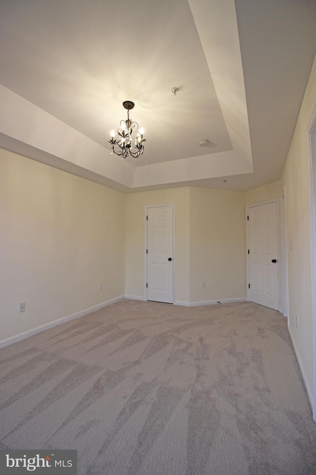 3655 Islington St, Frederick, MD 21704 - empty room featuring a raised ceiling, a chandelier, light carpet, and baseboards