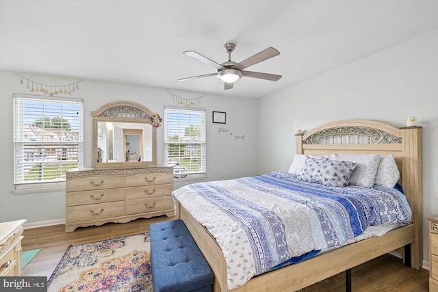 1931 Fort Monroe Ct, Dumfries, VA 22026 - bedroom featuring multiple windows, wood finished floors, and a ceiling fan