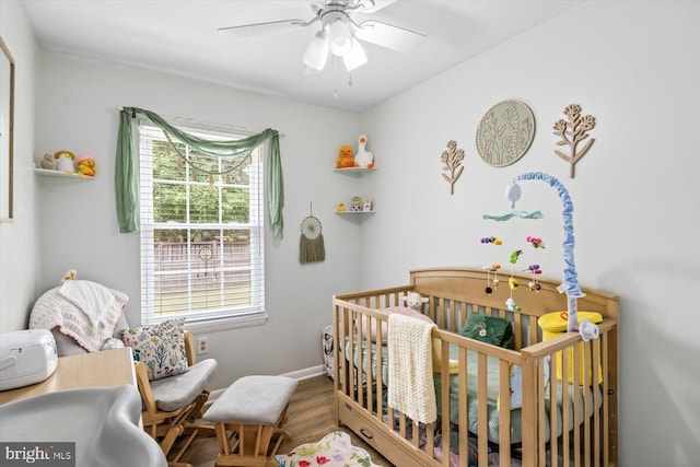1931 Fort Monroe Ct, Dumfries, VA 22026 - bedroom featuring a nursery area, wood finished floors, and ceiling fan