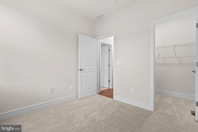 23062 Soaring Heights Ter, Ashburn, VA 20148 - unfurnished bedroom with carpet, baseboards, a spacious closet, and a closet