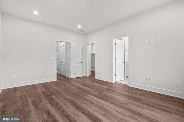 23062 Soaring Heights Ter, Ashburn, VA 20148 - unfurnished bedroom featuring wood finished floors, baseboards, a spacious closet, and recessed lighting