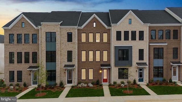 23062 Soaring Heights Ter, Ashburn, VA 20148 - view of property featuring brick siding and a front yard