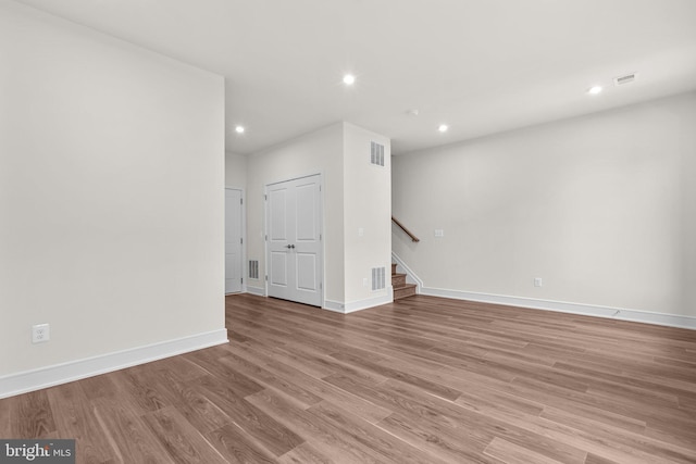 23062 Soaring Heights Ter, Ashburn, VA 20148 - unfurnished room with recessed lighting, stairway, light wood finished floors, and baseboards