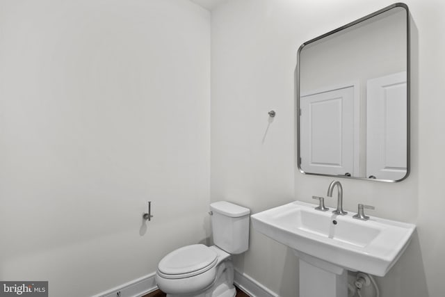 23062 Soaring Heights Ter, Ashburn, VA 20148 - half bathroom with toilet, baseboards, and a sink