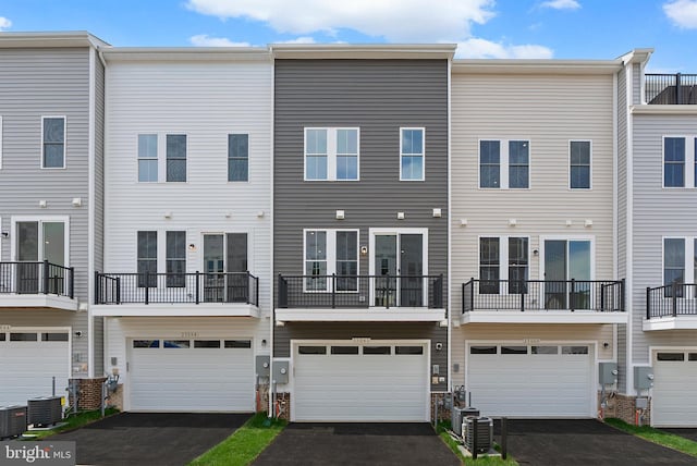 23062 Soaring Heights Ter, Ashburn, VA 20148 - rear view of house with driveway, a garage, and central AC