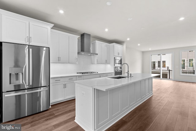 23062 Soaring Heights Ter, Ashburn, VA 20148 - kitchen with stainless steel appliances, wall chimney exhaust hood, a sink, a kitchen island with sink, and dark wood-style floors