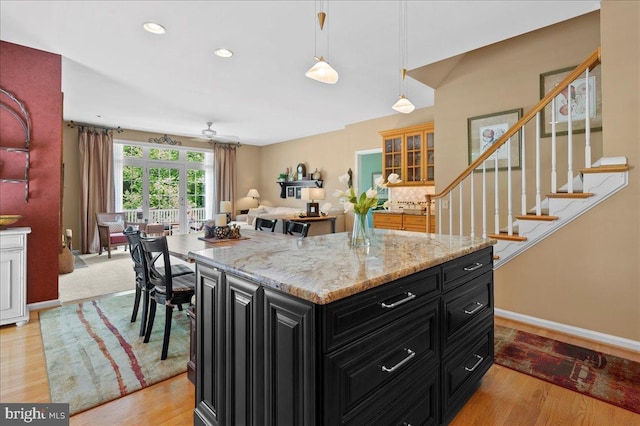 111 Brookline Ct, Avondale, PA 19311 - kitchen with dark cabinets, hanging light fixtures, recessed lighting, light wood-style flooring, and light stone countertops
