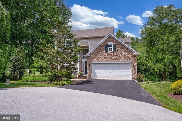 111 Brookline Ct, Avondale, PA 19311 - view of front of home with stone siding, driveway, and a garage