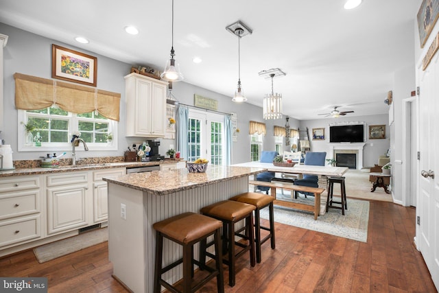 550 Long Meadow Dr, Fredericksburg, VA 22406 - kitchen featuring a ceiling fan, a kitchen island, recessed lighting, a fireplace, and light stone countertops