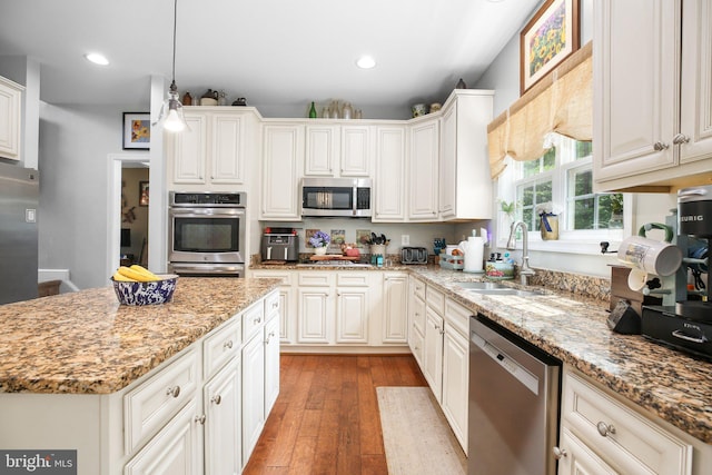 550 Long Meadow Dr, Fredericksburg, VA 22406 - kitchen featuring appliances with stainless steel finishes, hardwood / wood-style flooring, recessed lighting, light stone counters, and white cabinetry