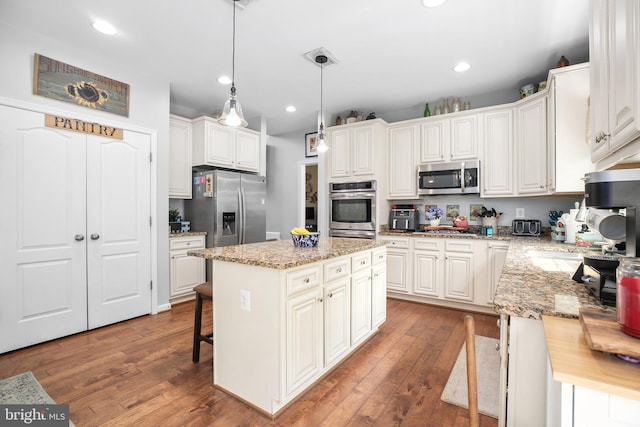 550 Long Meadow Dr, Fredericksburg, VA 22406 - kitchen featuring stainless steel appliances, hardwood / wood-style flooring, a center island, white cabinets, and recessed lighting