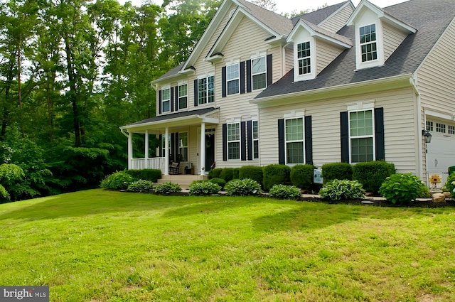 550 Long Meadow Dr, Fredericksburg, VA 22406 - colonial house with covered porch, a front lawn, roof with shingles, and a garage