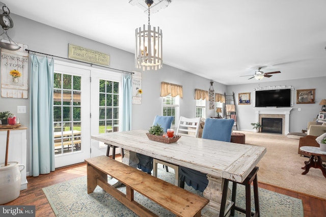 550 Long Meadow Dr, Fredericksburg, VA 22406 - dining space featuring a glass covered fireplace, ceiling fan, wood finished floors, and a chandelier