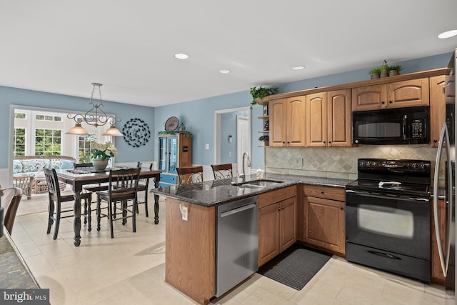 4 False Heather Way, Medford, NJ 08055 - kitchen featuring black appliances, a sink, backsplash, dark stone counters, and a peninsula