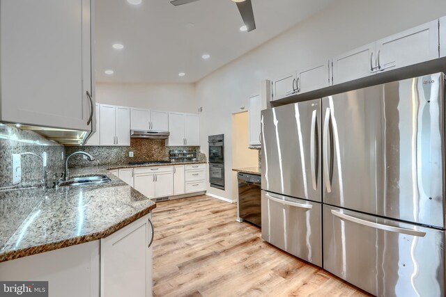 2409 Lightfoot Dr, Baltimore, MD 21209 - kitchen featuring black appliances, a sink, light stone countertops, tasteful backsplash, and white cabinetry