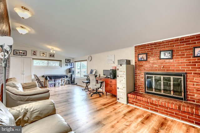 2409 Lightfoot Dr, Baltimore, MD 21209 - living room featuring a fireplace, wood finished floors, a desk, and lofted ceiling