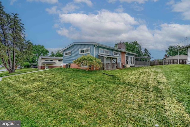 2409 Lightfoot Dr, Baltimore, MD 21209 - back of house featuring a chimney and brick siding