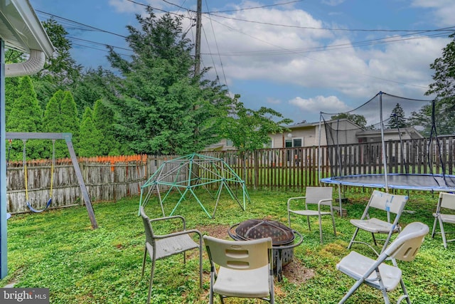 2409 Lightfoot Dr, Baltimore, MD 21209 - view of yard with a trampoline and an outdoor fire pit
