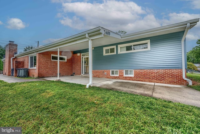 2409 Lightfoot Dr, Baltimore, MD 21209 - back of property featuring a yard, a patio, and brick siding
