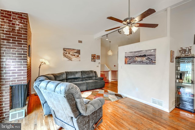2409 Lightfoot Dr, Baltimore, MD 21209 - living room with rail lighting, a ceiling fan, wood-type flooring, baseboards, and high vaulted ceiling