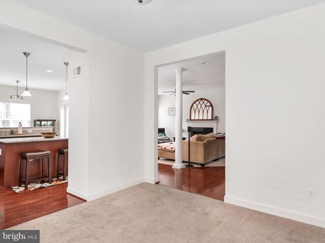 83 Clarence Ave, Severna Park, MD 21146 - living room with dark carpet, ceiling fan, a fireplace, and baseboards