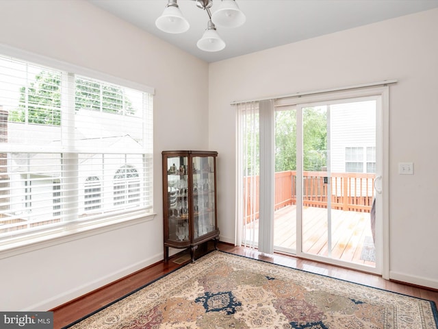 83 Clarence Ave, Severna Park, MD 21146 - unfurnished room with wood finished floors, healthy amount of natural light, baseboards, and a chandelier