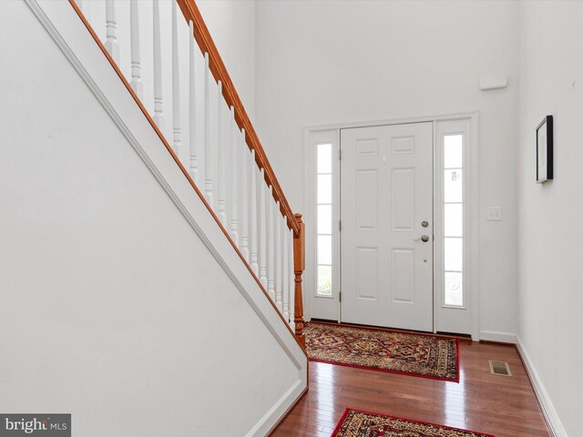 83 Clarence Ave, Severna Park, MD 21146 - entryway with wood finished floors, stairs, a towering ceiling, and baseboards