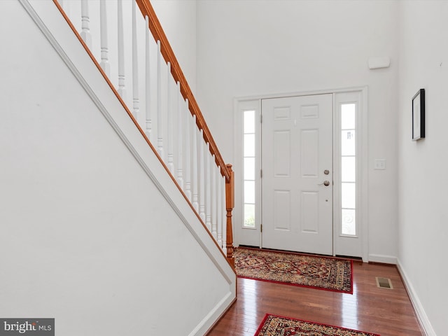 83 Clarence Ave, Severna Park, MD 21146 - foyer with wood finished floors, stairway, a towering ceiling, and baseboards