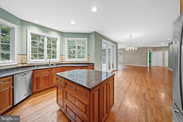 1 Derbyshire Way, Wilmington, DE 19807 - kitchen with appliances with stainless steel finishes, a chandelier, brown cabinetry, light wood finished floors, and recessed lighting