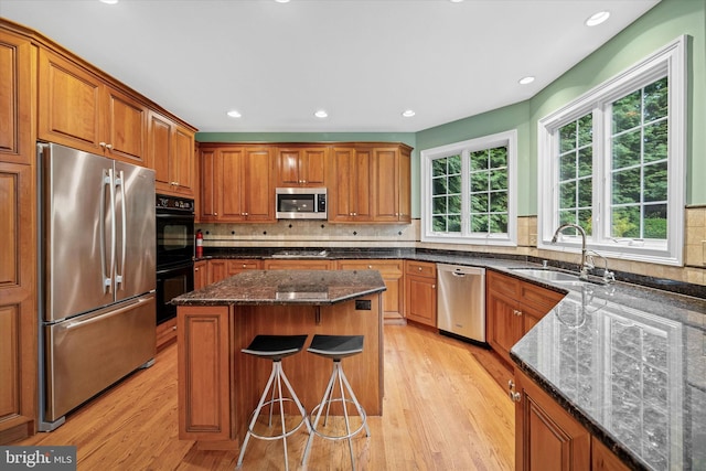 1 Derbyshire Way, Wilmington, DE 19807 - kitchen with stainless steel appliances, light wood-style flooring, brown cabinetry, a center island, and recessed lighting