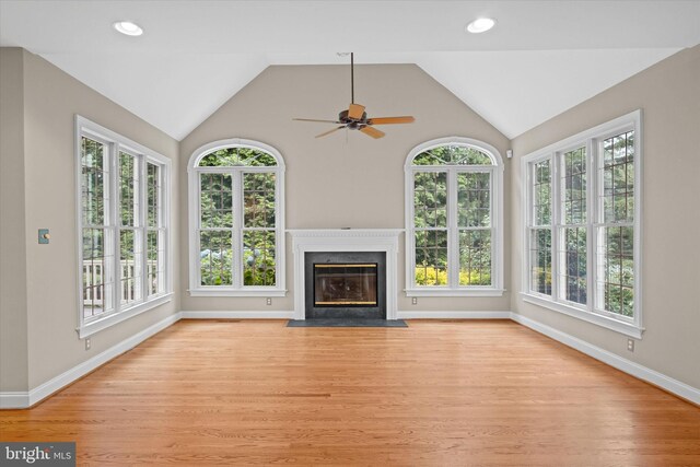 1 Derbyshire Way, Wilmington, DE 19807 - unfurnished living room with ceiling fan, healthy amount of natural light, light wood finished floors, vaulted ceiling, and a fireplace with flush hearth
