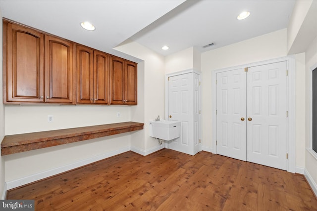 1 Derbyshire Way, Wilmington, DE 19807 - kitchen with wood finished floors, brown cabinetry, recessed lighting, and dark countertops