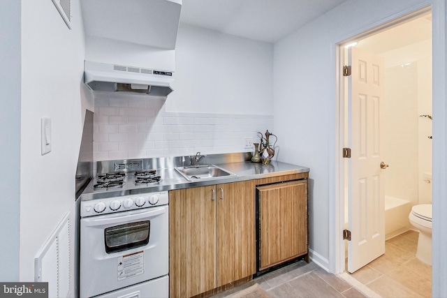 251 8th St NE, Washington, DC 20002 - kitchen featuring stainless steel countertops, under cabinet range hood, a sink, oven, and backsplash