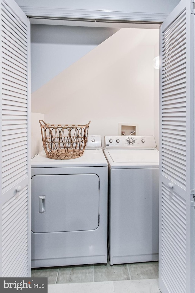 251 8th St NE, Washington, DC 20002 - washroom with washing machine and clothes dryer and light tile patterned floors