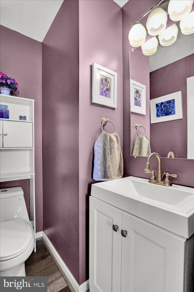 701 Antietam Dr, Douglassville, PA 19518 - half bath with toilet, wood finished floors, vanity, and baseboards