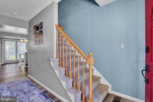 701 Antietam Dr, Douglassville, PA 19518 - staircase with a chandelier, baseboards, and wood finished floors