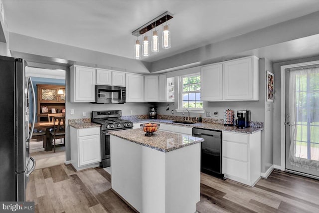 701 Antietam Dr, Douglassville, PA 19518 - kitchen featuring appliances with stainless steel finishes, a sink, light wood-type flooring, and white cabinets