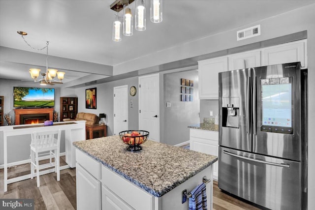 701 Antietam Dr, Douglassville, PA 19518 - kitchen with stainless steel fridge, a chandelier, light wood-type flooring, a kitchen island, and white cabinets