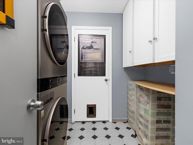 9112 Chesapeake Ave, Sparrows Point, MD 21219 - laundry area featuring stacked washing machine and dryer, cabinet space, and light floors