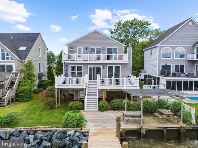 9112 Chesapeake Ave, Sparrows Point, MD 21219 - rear view of house with stairs, a balcony, a deck with water view, and a yard