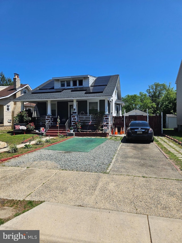 1666 Browning Rd, Pennsauken, NJ 08110 - view of front of house with roof mounted solar panels, roof with shingles, and a porch
